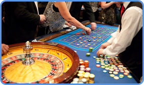 Roulette croupier and players at the roulette table